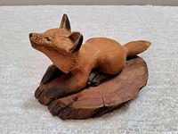 Front angle of vintage hand-carved wooden fox sculpture showing detailed texture and natural wood tones