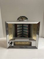 Front view of the Seeburg Wall-O-Matic jukebox wall box showing the chrome frame, stereo text, selection buttons, and top dome unit.