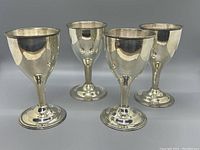 Four goblets arranged in two rows on gray background