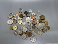 Top view of mixed coins laid out, showing diversity in type, size, and country.
