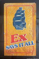 Front view of vintage Molson Ex advertising sign showing 3D plastic sailing ship and text 'Ex Says It All' on textured yellow background with damage to edges.