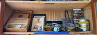 Wooden tray containing assorted fly tying materials, some in plastic bags, a 'Mallard Breast' labeled box and a 'House of Lords Petit Coronas' box closed