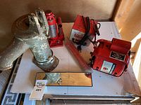 Full view of Armstrong motor, Allstate charger, and Galaxy 3 ton jack on table