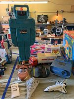 Wide view showing large robot, toy spaceship, projection camera, and toy truck among other vintage toys