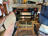 Full view of Black & Decker Workmate 550 with wooden saw holder and two hand saws