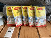 Four boxes of Aeroxon Clothes Moth Trap, each box containing 2 traps, stacked and arranged on wooden surface.