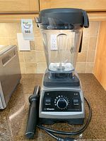 Full view of blender assembled with pitcher, lid, and tamper