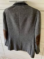 Back view of gray women's sport jacket showing brown suede elbow patches and clean seam design.