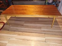 Top view showing rectangular rosewood tabletop with polished surface and tapered light wood legs.