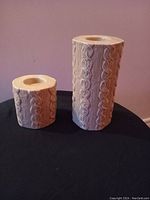 Photo of two cable knit pattern tea light candle holders, one large approx. 7.5 inches tall and one small approx. 4.5 inches tall, both holding standard tea lights.
