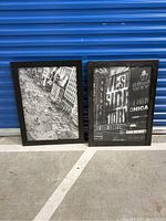 Two black framed photographs of NYC Times Square and Broadway scenes with visible urban street and billboards in black and white.