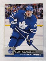 Front of the 2016-17 Upper Deck Auston Matthews rookie hockey card showing player image and team logo.