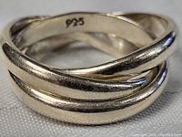 Close-up of inside band showing 925 sterling silver marking and surface texture.