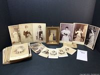 Overhead view showing the framed Camille Urso portrait at center surrounded by various cabinet cards.