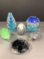 Group shot of all six art glass pieces on grey background