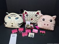 Full lot display showing three quilted animal-themed bags, bracelet and earrings