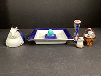 Full set of ceramic trinket boxes and dish displayed in a row.