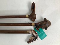 Angled overhead view of three canes showing full shafts and handles