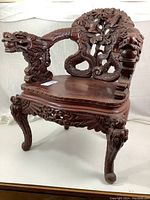 Full front view of the chair showing overall carved design and finish