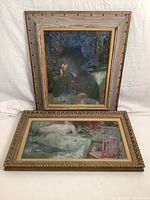 Two original oil paintings on canvas with frames displayed, one portrait and one nude scene, showing size difference and frame designs.