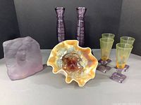 Photo showing all eight items including candy dish, female sculpture, four wine glasses, and two candle sticks arranged together for scale and group display.