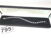 Full view of tennis bracelet in black velvet box