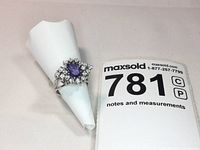 Front view of ring on white display cone with lot number card visible