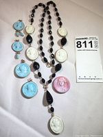 Full view of the necklace and 5 additional cameo medallions displayed on white background to show lot contents and components.