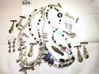 Full lot display of sea life themed jewelry including necklaces, pins, earrings, and brooches arranged on white background