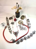 Three-piece grouping: silvertone bracelet, matching necklace and dragon ring