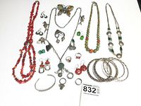 Flat lay of all 22 jewelry pieces on white background