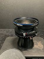 Front 3/4 view of lens showing Schneider-Kreuznach branding and aperture ring