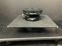 Side view of lens on board showing Schneider-Kreuznach branding and shutter speed ring