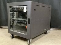 Front-side view of closed server rack cabinet on caster wheels