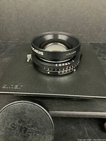 Front view of Sinaron S copal 1 72d 210mm f/5.6 lens showing lens front element and branding.