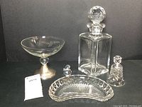 Full lot showing all five crystal and glass items laid together on a black background.