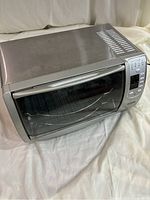 Front view of the stainless steel Oster convection oven showing glass door and overall condition.