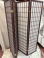 Full view of three-panel room divider painted in a redwood finish with white paper backing arranged in grid window style. Shows overall condition and design.