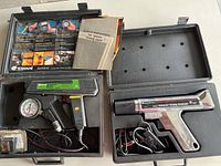 Overview of two Equus timing lights in molded hard plastic cases with instruction manuals and accessories.