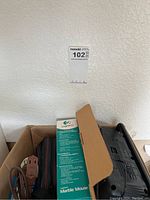 Photo showing Logitech Marble Mouse in original box with extension cords and power strip beside it