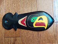 Top view of the hand carved and painted eagle head wooden carving showing intricate details of paint and carving work.