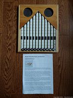 Wooden Horse Races custom built game board showing numbered vertical rods within a wooden frame and the printed rules sheet.