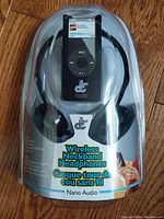 Front packaging showing wireless neckband headphones and receiver device with branding and product name details.