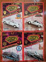 Four Road Champs State Police Series 1/43 scale diecast police cars in original retail packaging, new old stock condition.