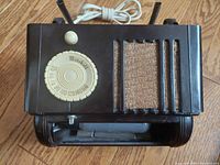 Top view of the vintage Mitchell Lullaby bed headboard lamp radio with rotary dial tuner, speaker grill, and antennas.