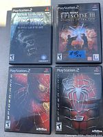 Photo showing 4 PlayStation 2 game cases: King Kong, Star Wars Episode III, Spider-Man, and Spider-Man 2.