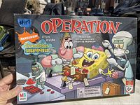 Front of the operation game box featuring Nickelodeon SpongeBob SquarePants Edition with SpongeBob, Patrick, Squidward, and Plankton characters.