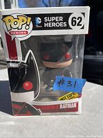 Funko Pop! Heroes Earth 2 Batman figure in original box, front view showing character and box number 62, with some damage to the box window.