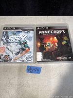 Photo shows two PS3 game cases side by side. On the left is SSX with cover featuring a snowboarder on snowy mountains. On the right is Minecraft PlayStation 3 Edition with pixel graphics cover.