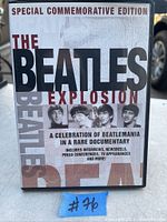 Photo of The Beatles Explosion DVD cover showing title, images of the four Beatles, and text describing the contents and special edition status.